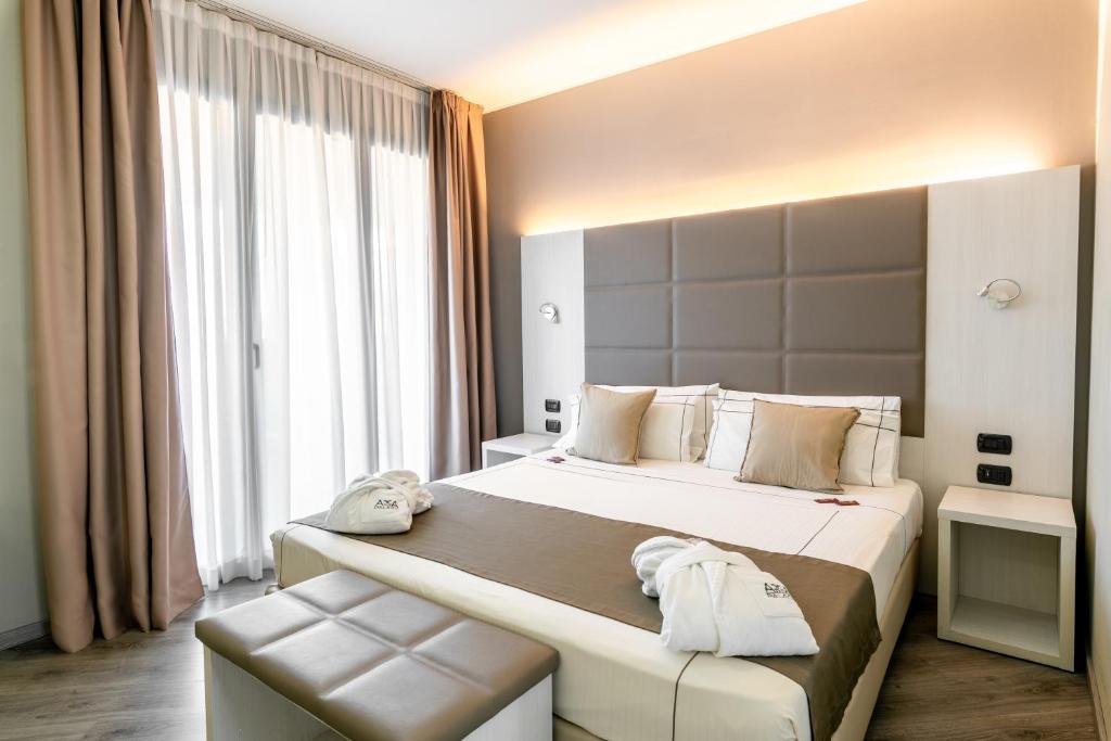 a bedroom with a large bed and a large window at Acca Palace AA Hotels in Milan