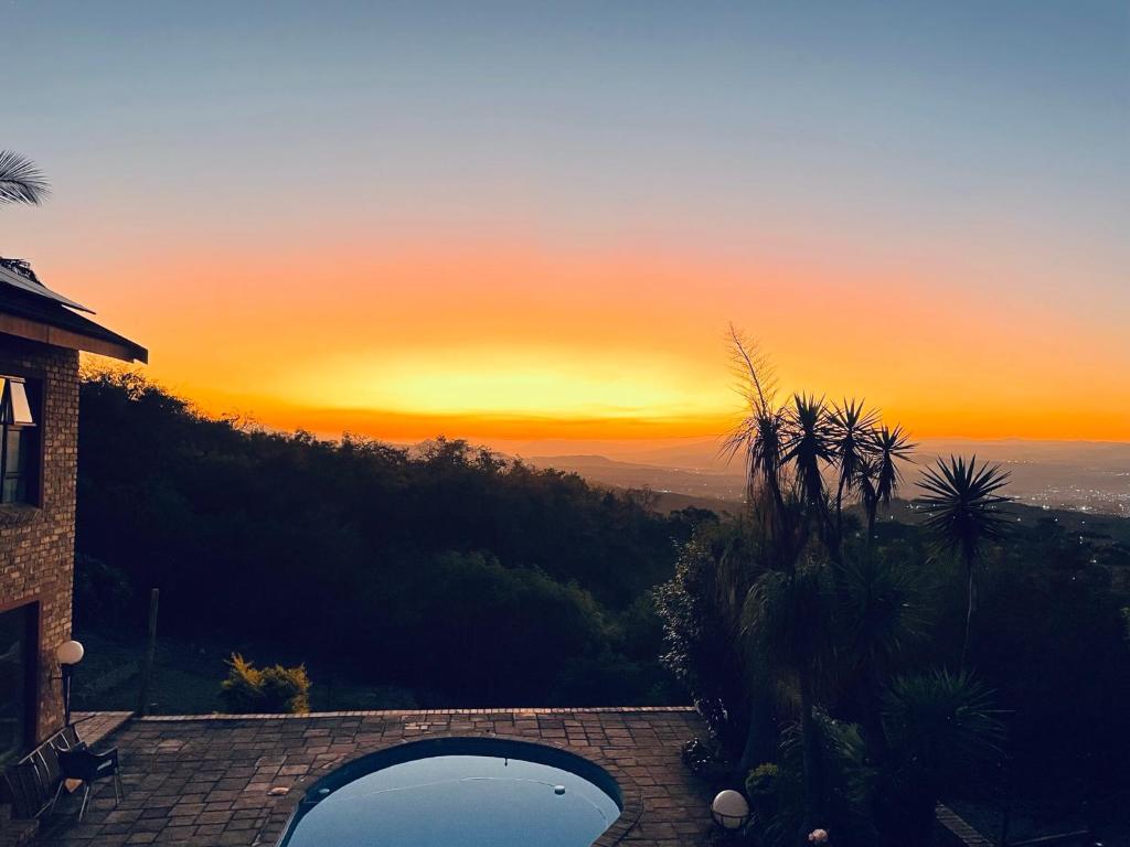 a view of a sunset from a house with a pool at The Haven in Nelspruit