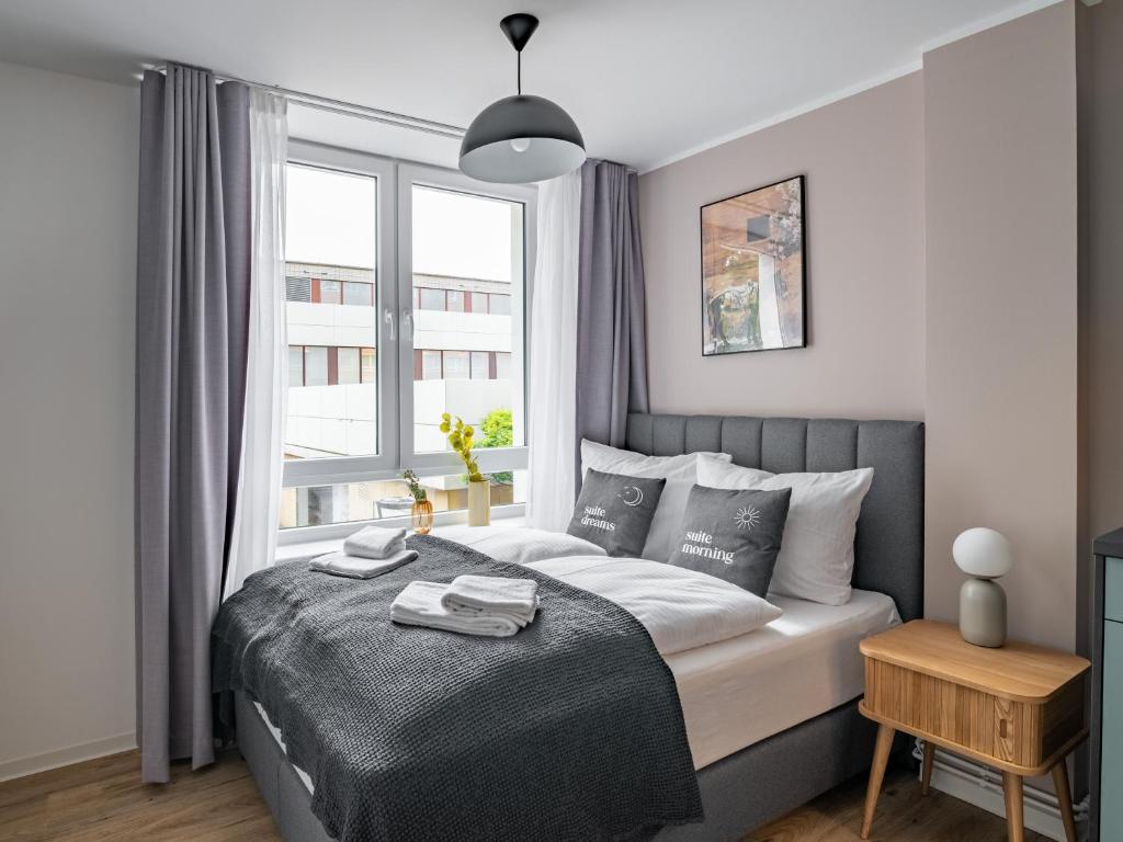 a bedroom with a bed and a large window at Limehome Salzgitter A-Schweitzer-Str in Salzgitter
