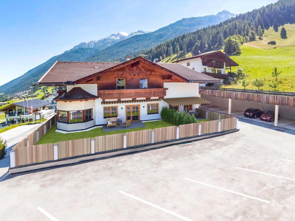 an aerial view of a building with a parking lot at Group Apartment in Stubaital with Ski Storage in Neustift im Stubaital