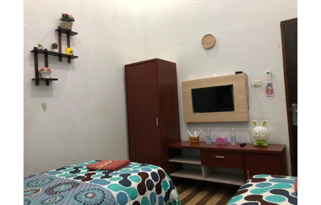Postel nebo postele na pokoji v ubytování Inalum Permata Guest House