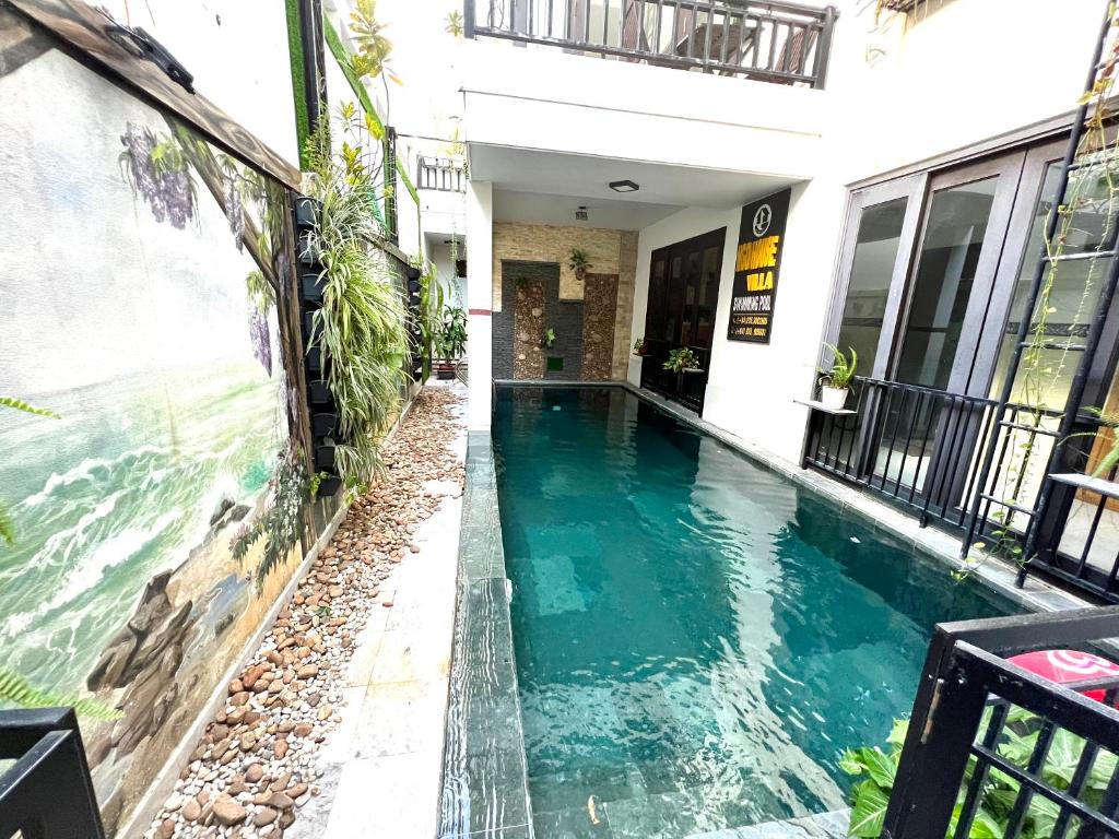 a swimming pool in the middle of a building at Ngo House Villa in Hoi An