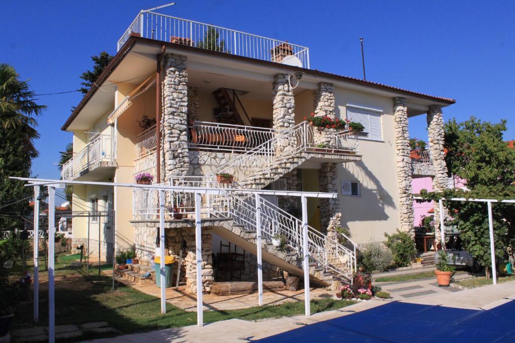 a building with stairs on the side of it at Apartments with a swimming pool Valbandon, Fazana - 7257 in Marana