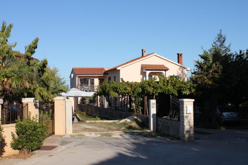 a house with a fence in front of it at Apartments with a parking space Liznjan, Medulin - 7214 in Ližnjan