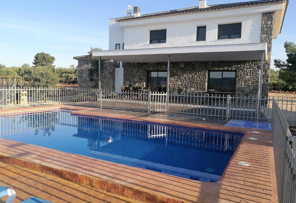 a swimming pool in front of a house at Casa Rural la Montana 2 in Chella