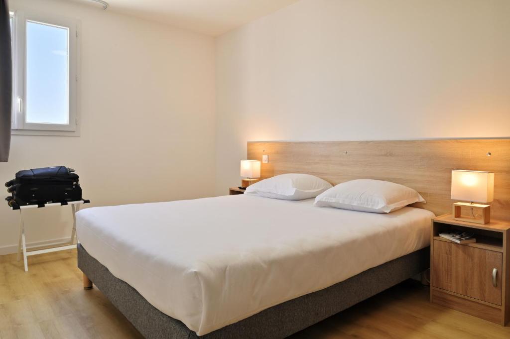 Łóżko lub łóżka w pokoju w obiekcie Résidence Easy Lodge