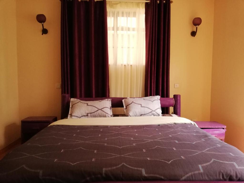 Letto o letti in una camera di MANI HOMES