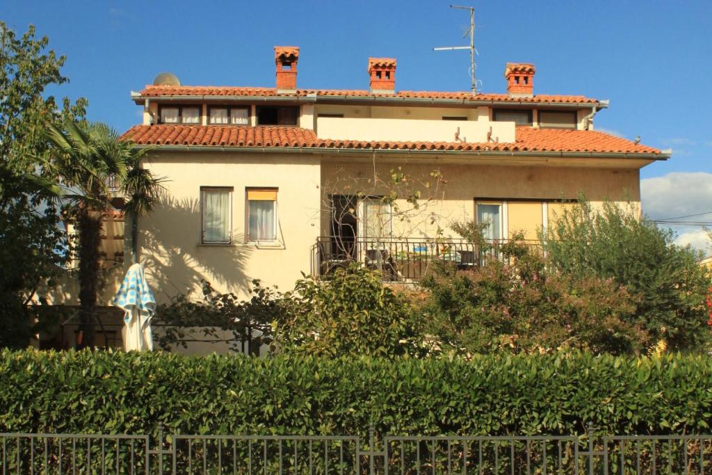 a white house with a red roof at Apartments with a parking space Medulin - 7328 in Medulin
