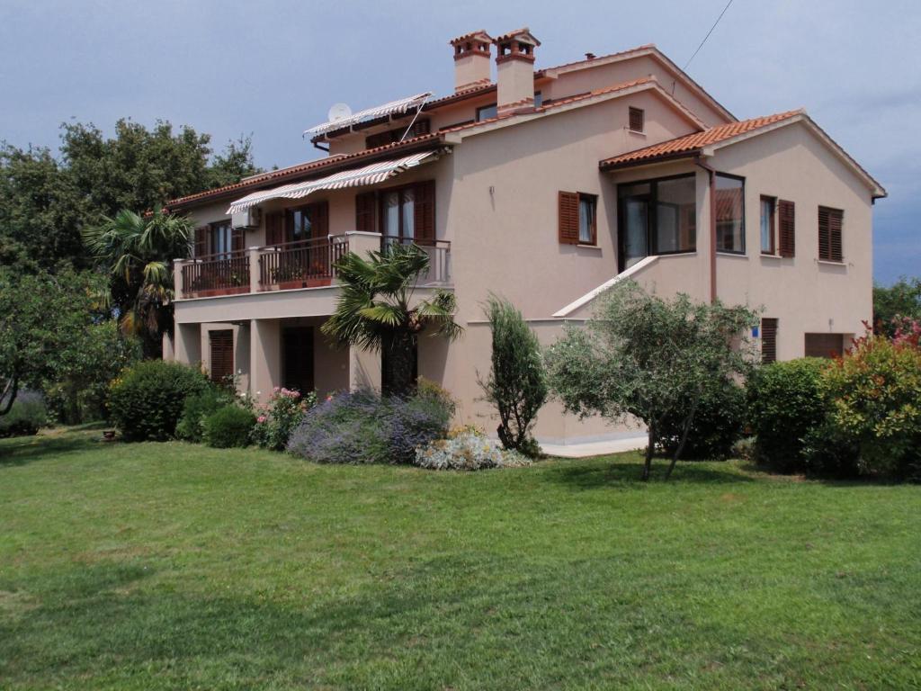 a large house with a lawn in front of it at Apartments with a parking space Presika, Labin - 7390 in Labin
