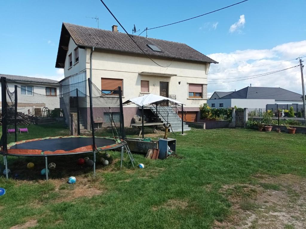 a house with a trampoline in the yard at Chez Georges et Colette in Saasenheim