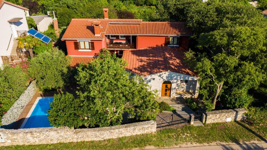 an aerial view of a house with a swimming pool at Family friendly apartments with a swimming pool Krnica, Marcana - 7357 in Krnica