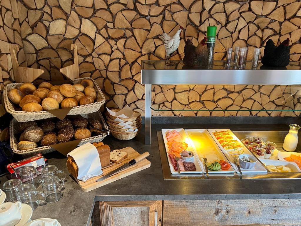 a buffet with bread and other foods on a table at Berghotel Lenneplätze Winterberg in Winterberg