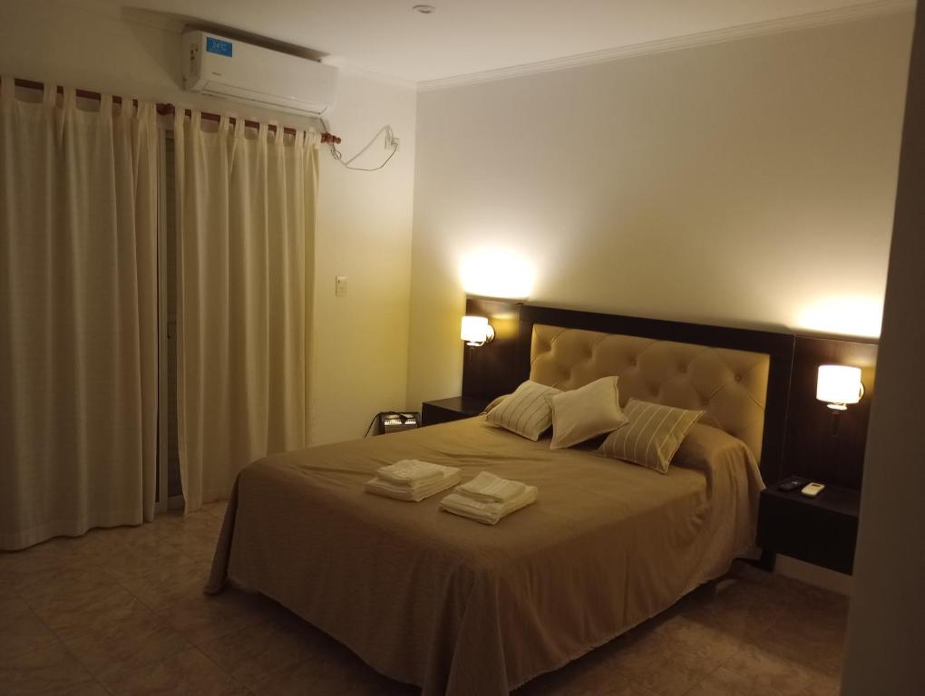 a bedroom with a large bed with two towels on it at Casa de Juan in Federación