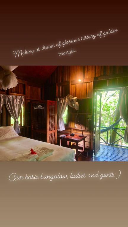a picture of a bedroom with a bed and a window at Bambu Huts in Baan Tai