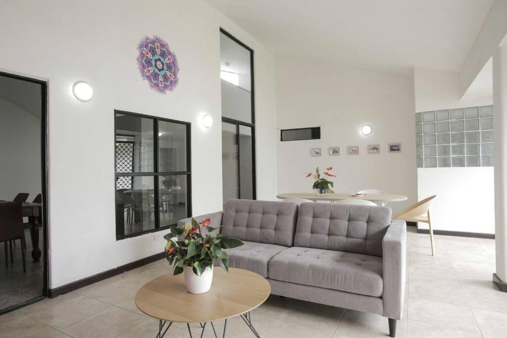 a living room with a couch and a table at Casa Mandala en Los Cristales in Cali