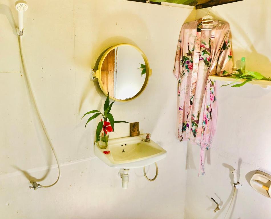 a bathroom with a sink and a mirror at Bambu Huts in Baan Tai