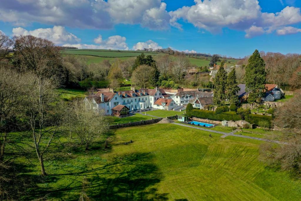 an aerial view of a village with houses and trees at Croydon Hall in Minehead