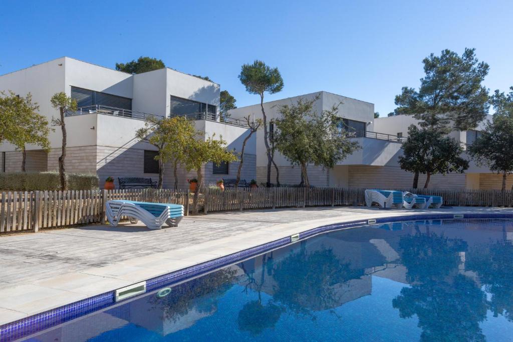 a swimming pool in front of a building at 4 Bedroom Modern House, Llafranc, Costa Brava in Llafranc