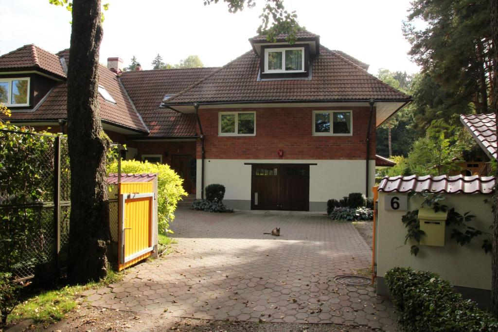 a house with a gate and a dog in front of it at Villa Tiigi in Tallinn