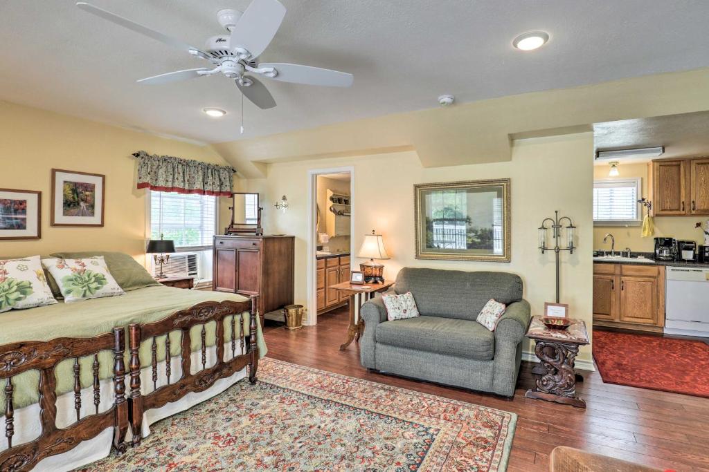 a bedroom with a bed and a chair and a kitchen at Studio in College Station with Expansive Deck! in College Station