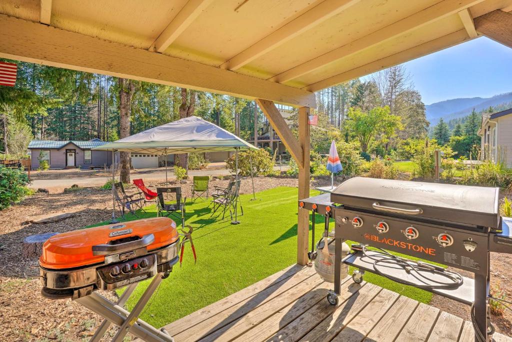 a barbecue grill on a deck with a backyard at Lovely Detroit Home with Deck - Walk to Town! in Detroit