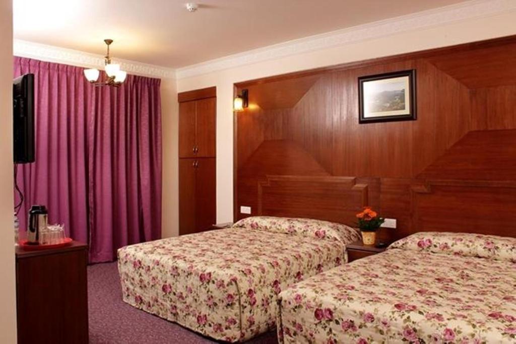 Postel nebo postele na pokoji v ubytování Jasmine Hotel