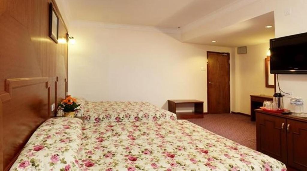 Postel nebo postele na pokoji v ubytování Jasmine Hotel