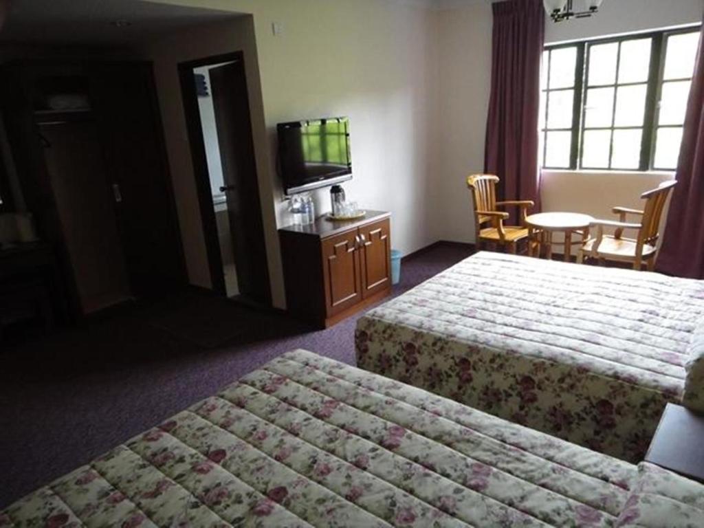 Postel nebo postele na pokoji v ubytování Jasmine Hotel