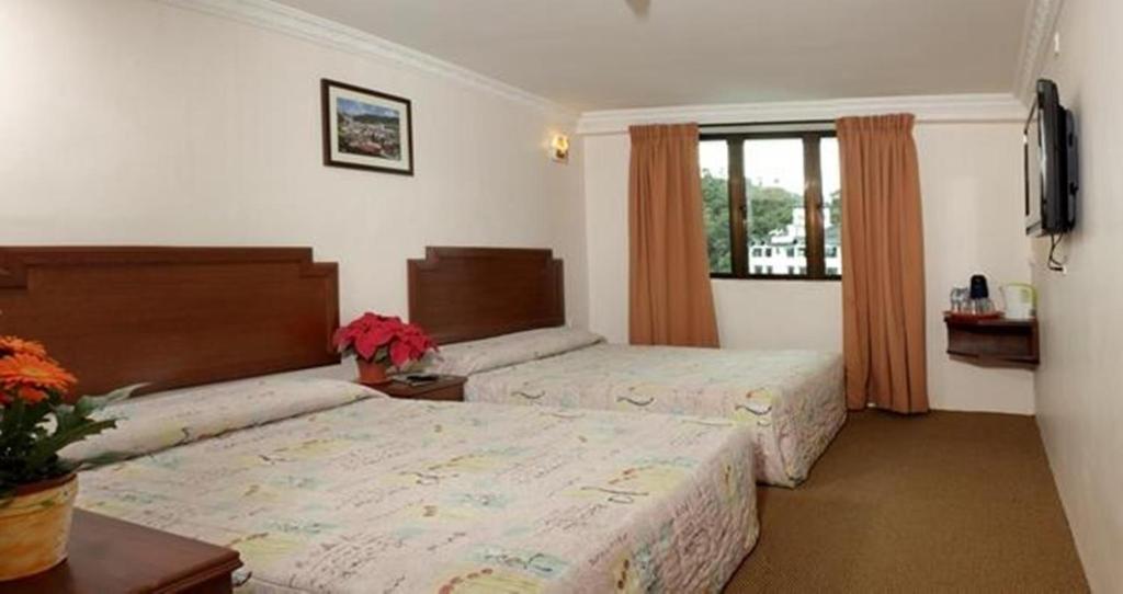 Postel nebo postele na pokoji v ubytování Jasmine Hotel