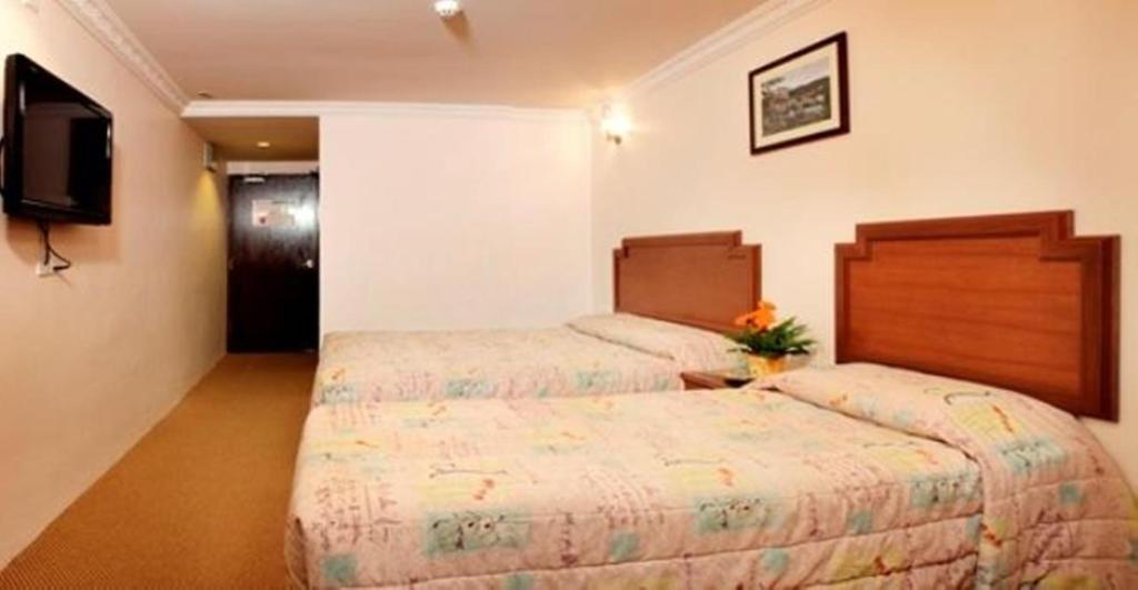 Postel nebo postele na pokoji v ubytování Jasmine Hotel