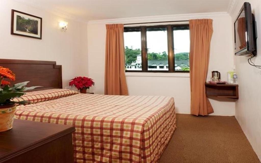 Postel nebo postele na pokoji v ubytování Jasmine Hotel