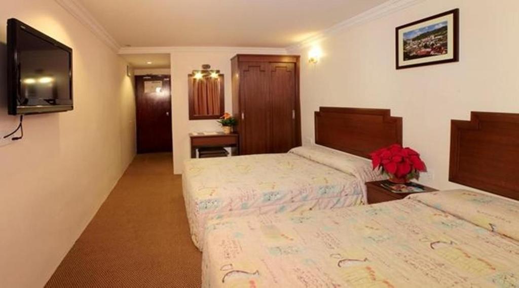 Postel nebo postele na pokoji v ubytování Jasmine Hotel