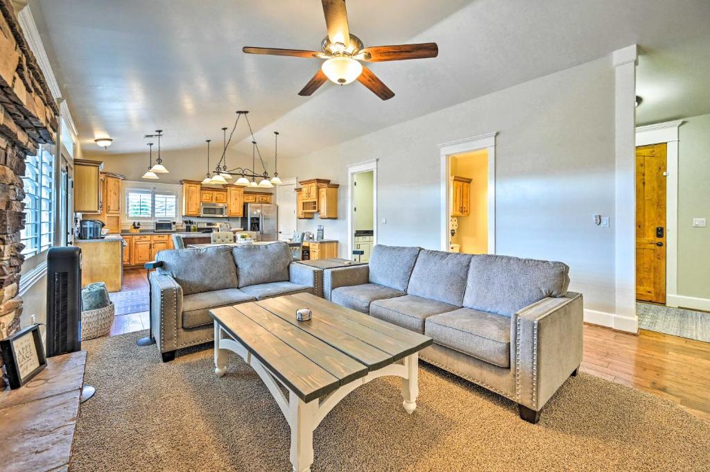 a living room with two couches and a table at Classy Bellemont Home with Hot Tub and Playground in Bellemont