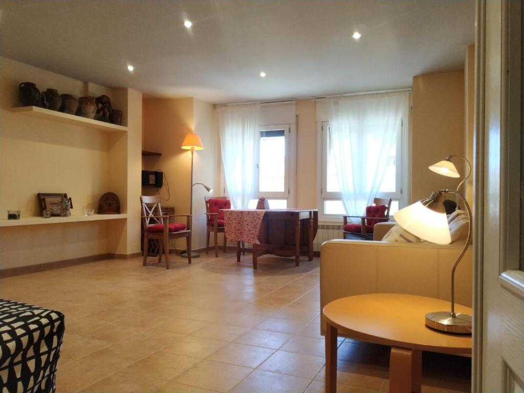 a living room with a couch and a table at Apartamento EntreRíos in Barbastro