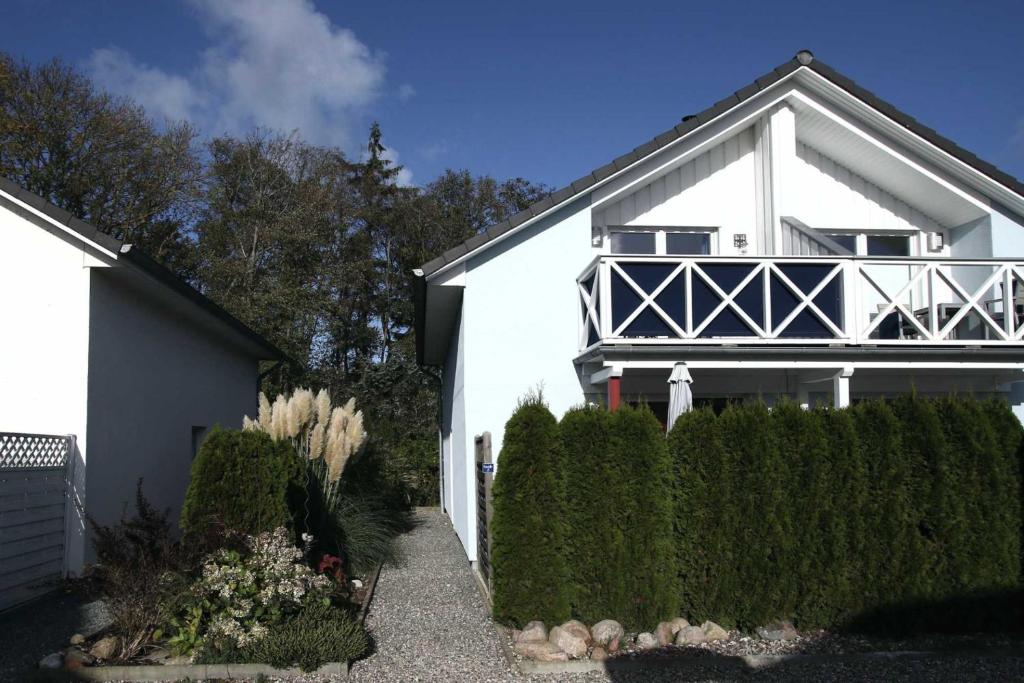 a white house with a fence in front of it at Seeadler 3 - Süssau in Süssau