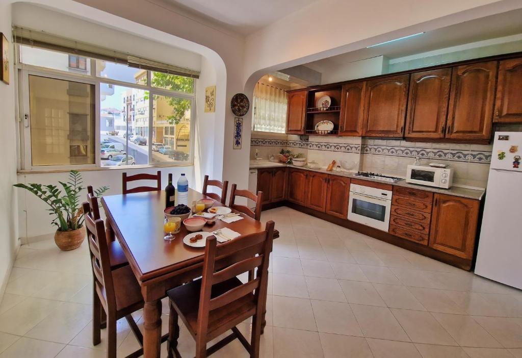 a kitchen with a table and chairs and a refrigerator at Tavira City Center 3Br in Tavira