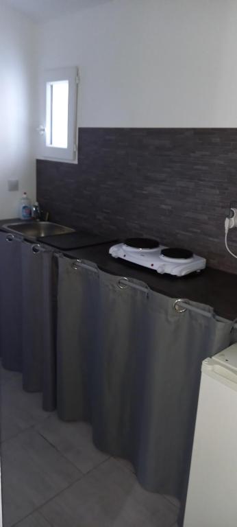 a kitchen with a counter top and a sink at Studio in Sorgues