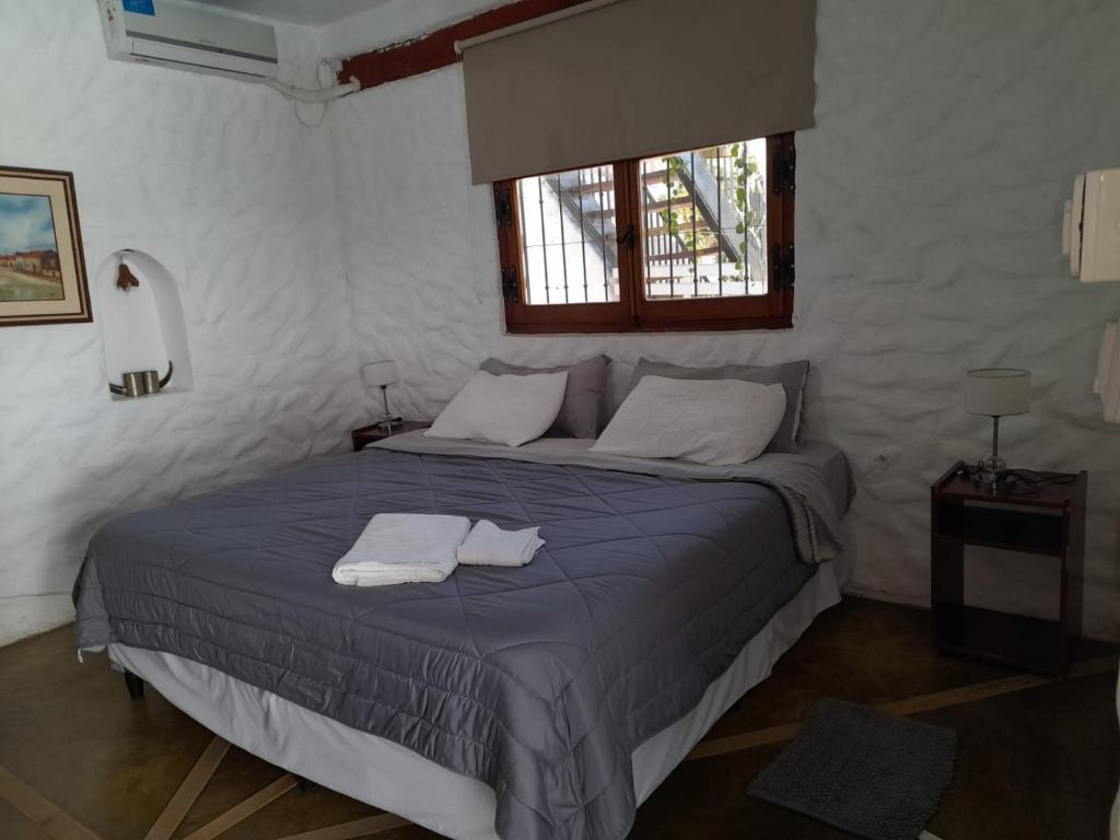 a bedroom with a bed with two towels on it at Hotel Andino - Adults Only in Cafayate