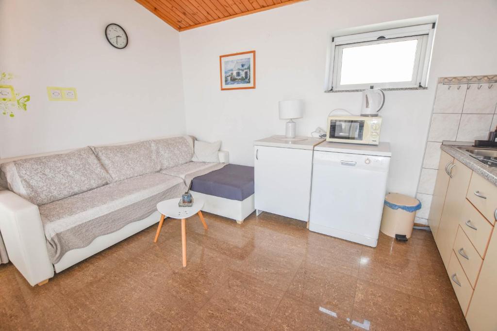 a living room with a couch and a microwave at Apartments Ante in Pakoštane