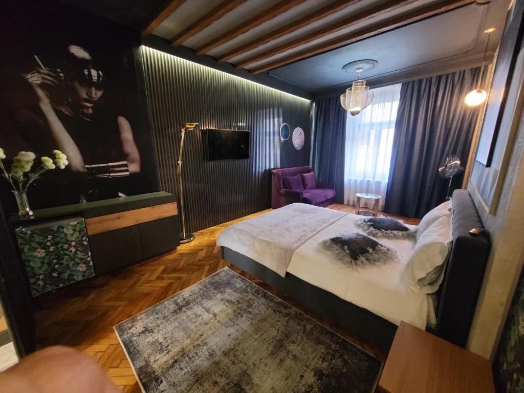 a bedroom with a large bed and a bathroom at Alfa Luxury Boutique in Sibiu