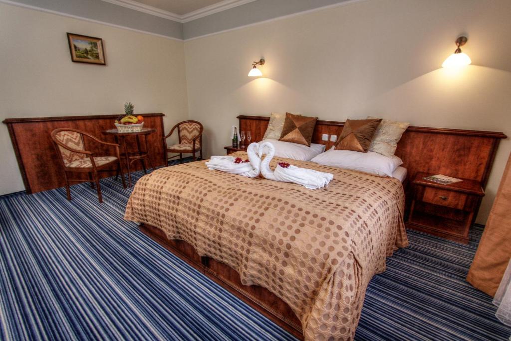 Postel nebo postele na pokoji v ubytování Spa & Wellness Hotel Harmonie
