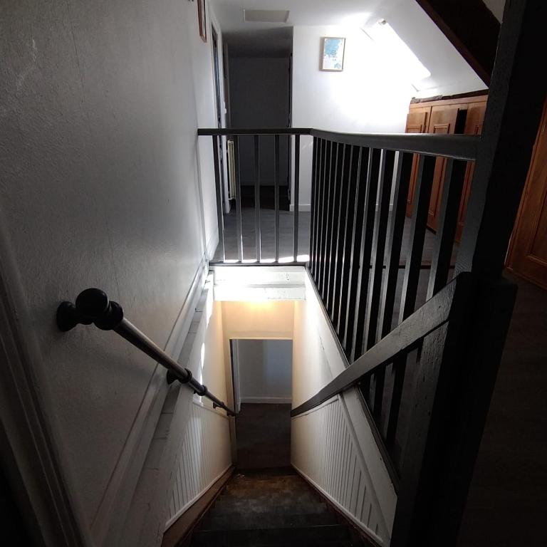 an overhead view of a stairway with a light at the top at Halles Brauhauban Tarbes - T6 en collocation - Louez votre chambre in Tarbes