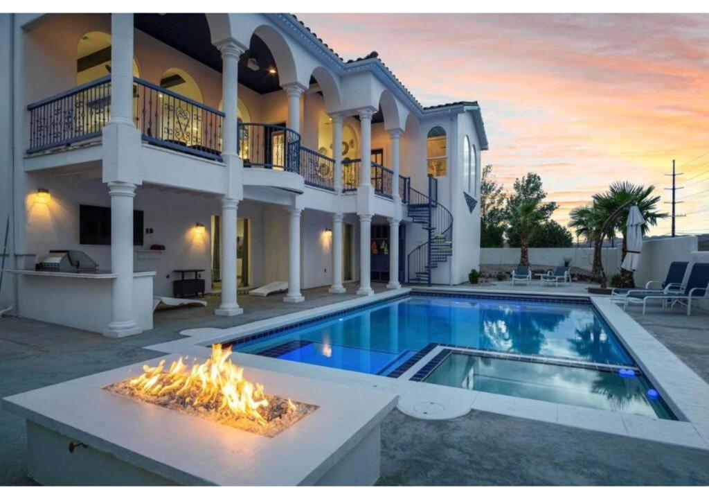 a house with a swimming pool with a fire pit at Greek Goddess, Private Heated Pool and Hot Tub in Hurricane