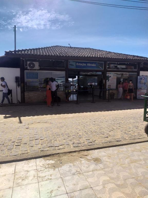 a group of people standing outside of a building at Casa do Cais in Abraão