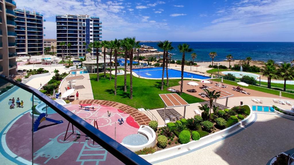 an aerial view of a resort with a pool and the ocean at Apartamento Sea Senses in Torrevieja