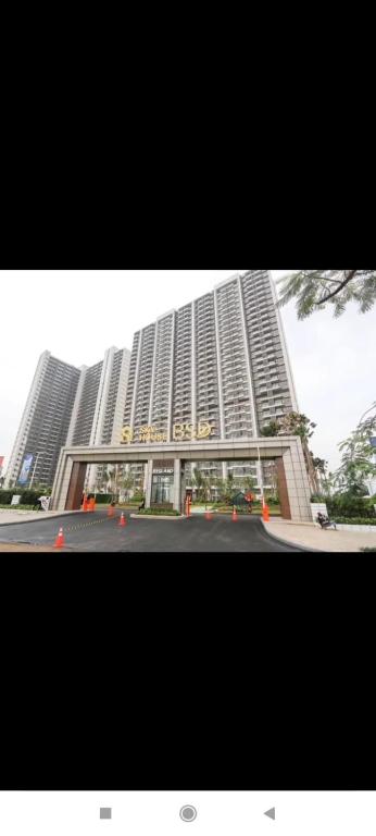 a large tall building with a street in front of it at Precious Angel Apartment Sky House BSD in Pagedangan
