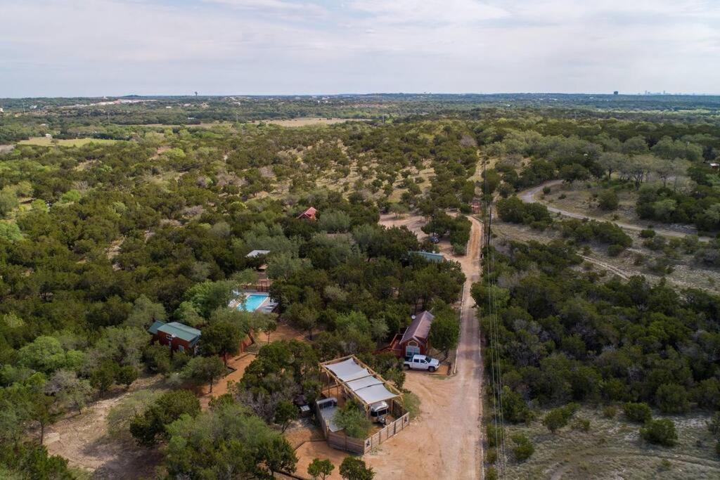 an aerial view of a house with a pool at Fox Tiny Home - The Cabins at Rim Rock in Austin