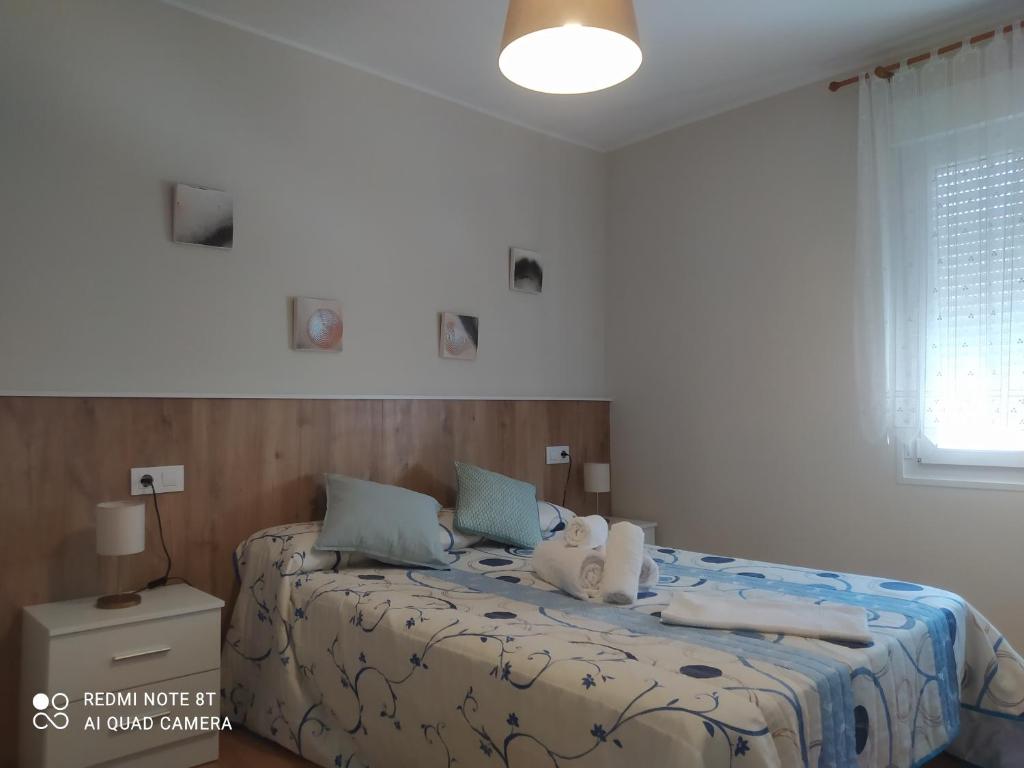 Postel nebo postele na pokoji v ubytování Vivienda turística Ramón Trillo en Muxía