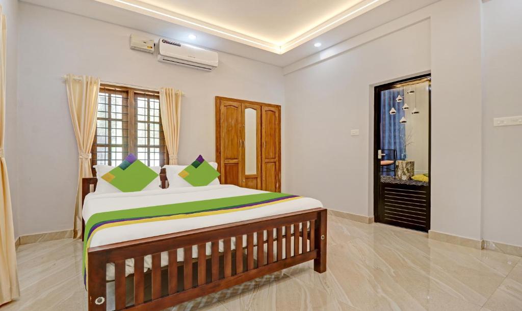 a bedroom with a large bed in a room at Itsy By Treebo - Palm Grove By D2V in Cochin