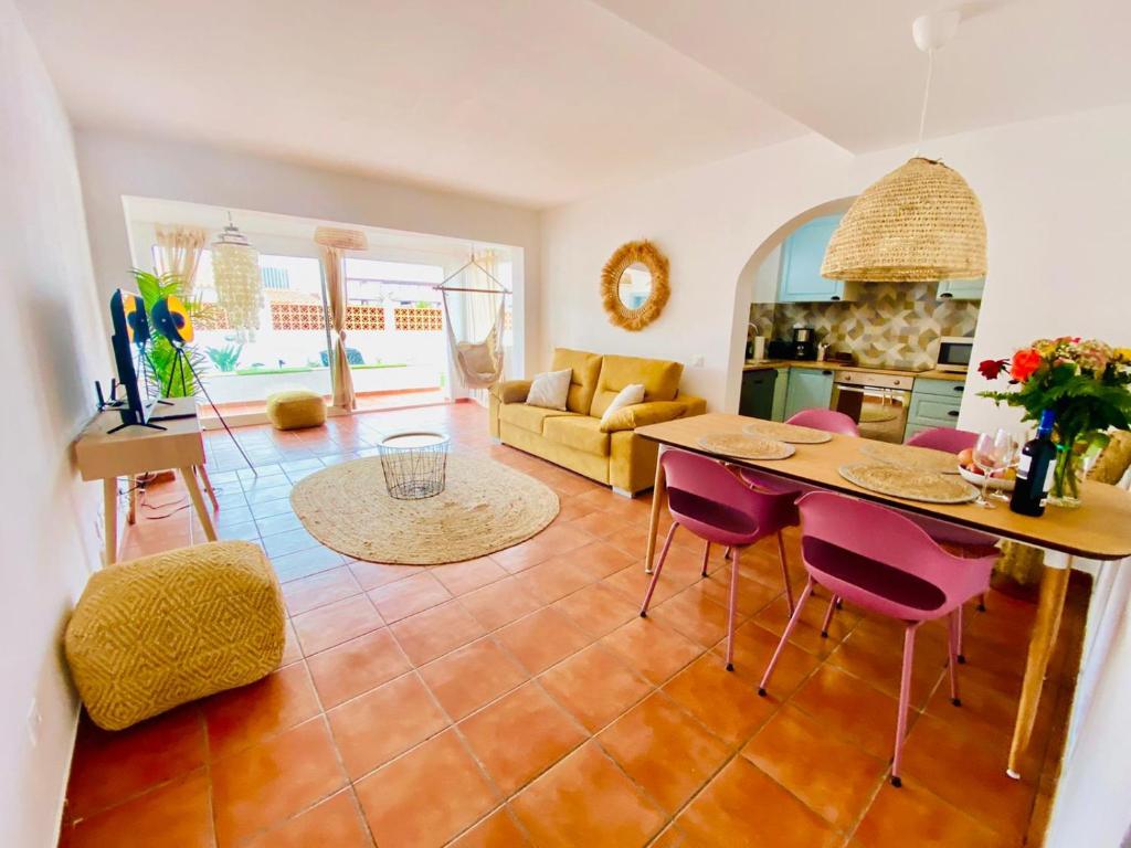 a kitchen and living room with a table and chairs at Golden Wave Surf Villa in Corralejo